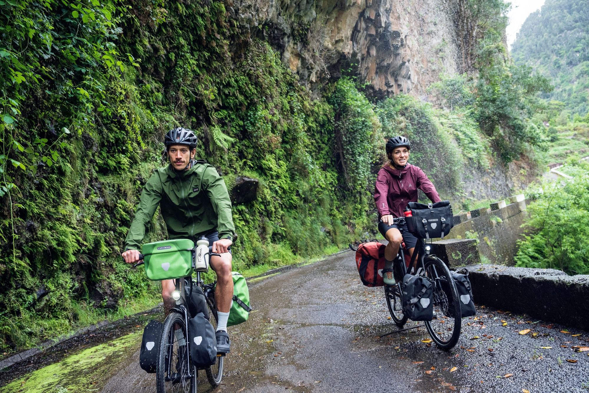 Zwei Radfahrer auf Regentour mit beladenen Fahrrädern. Perfekt für Abenteurer und Naturliebhaber.