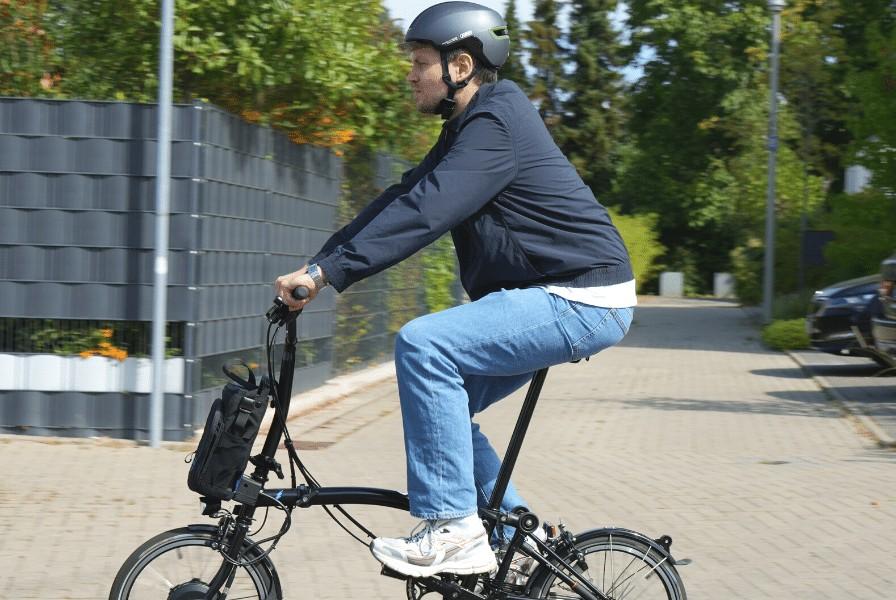 Das Bild zeigt Lennart auf einem Brompton Klapp e-Bike C-Line