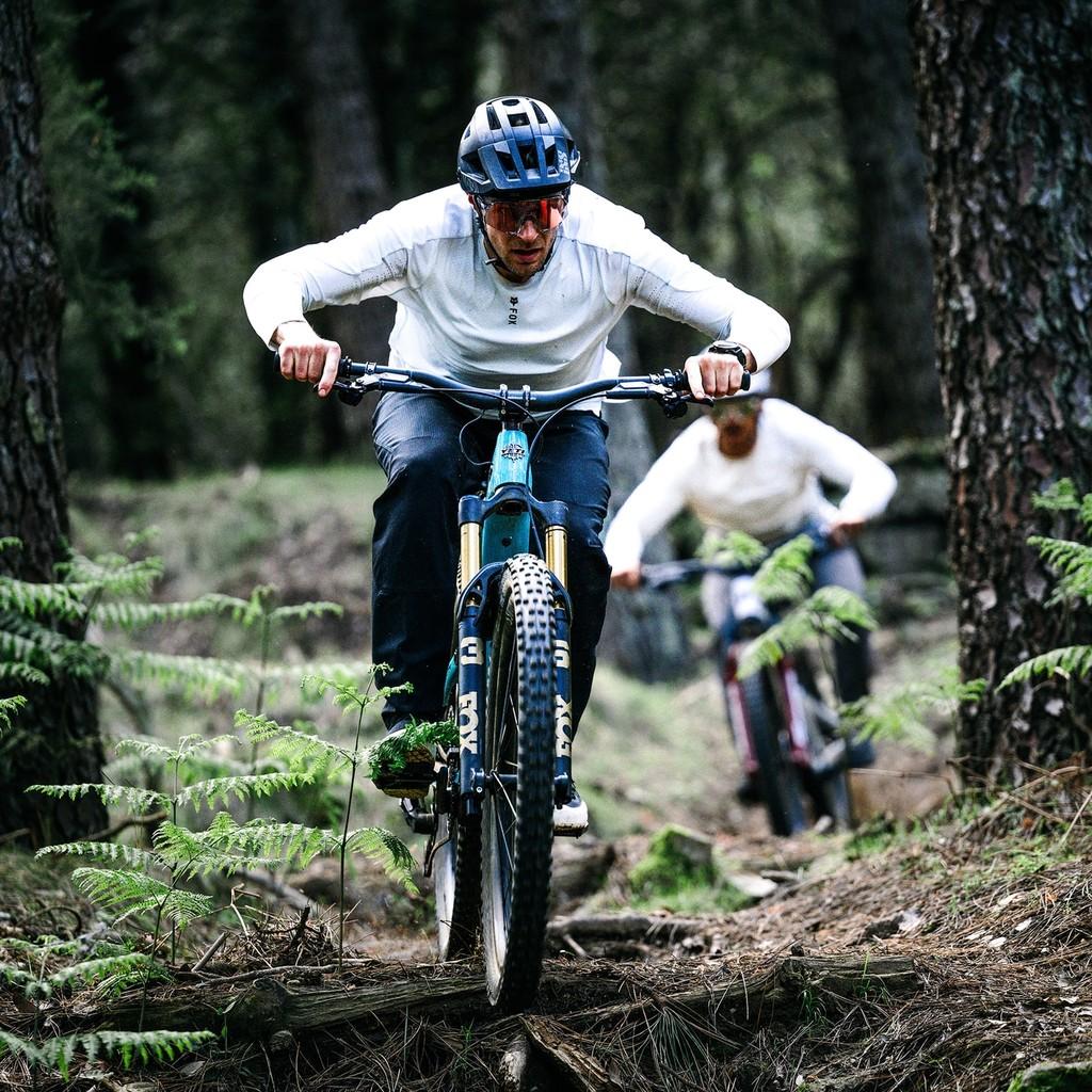 Zwei Personen fahren auf Haibike e-MTBs durch den Wald