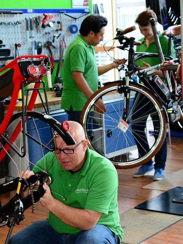 Professionelle E-Bike Wartung bei Emotion Technologies: Techniker arbeiten an Fahrrädern mit Sorgfalt und Expertise