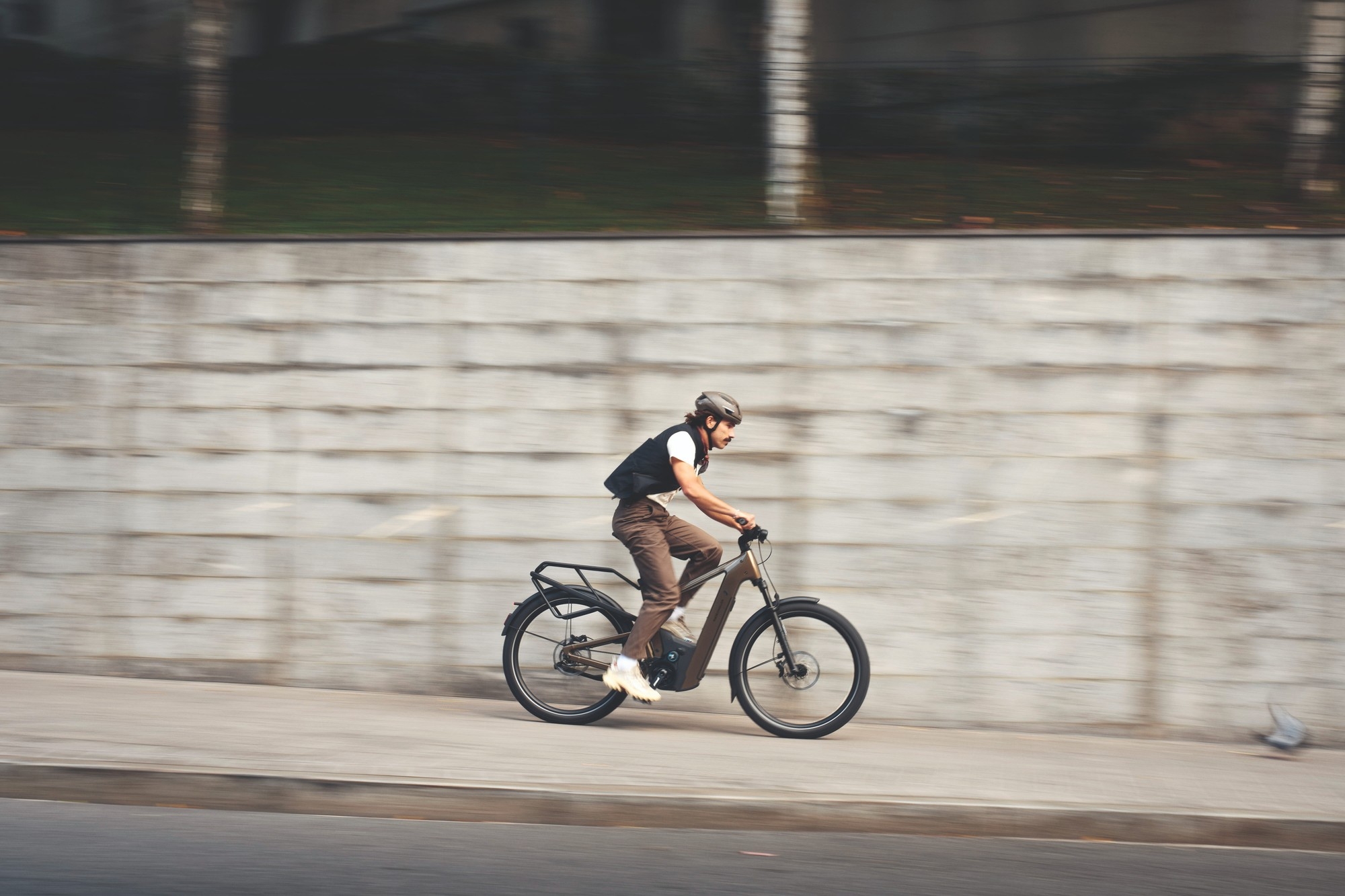 Das Bild zeigt ein E-Bike des Delite5 GT, ausgestattet mit einem Pinion-Getriebe, in einer auffälligen Amber-Farbe.