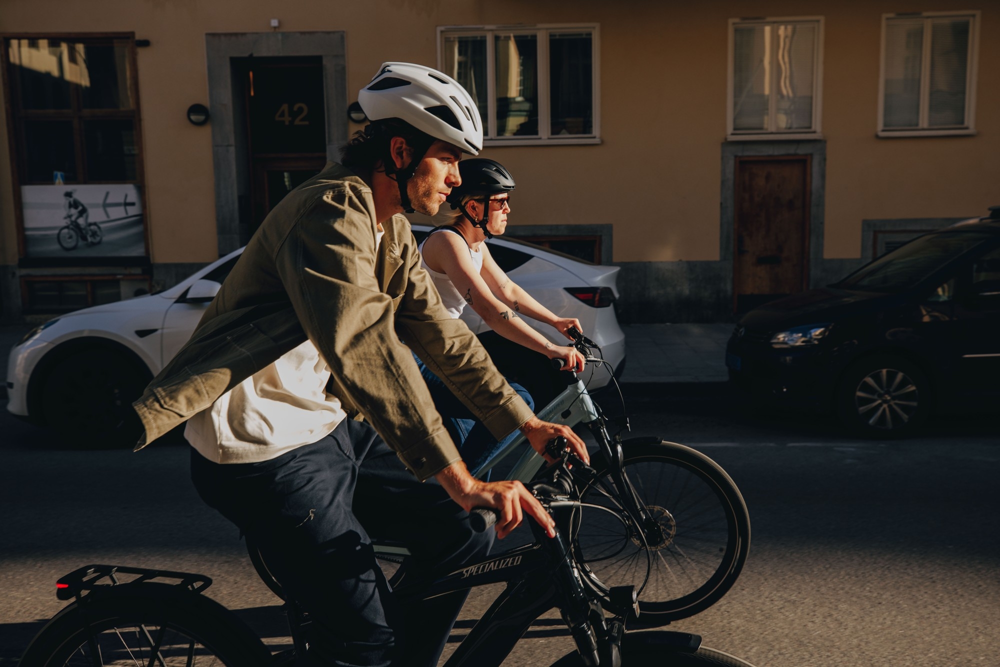 Zwei Mitarbeiter fahren auf Specialized e-Bikes durch die Stadt.